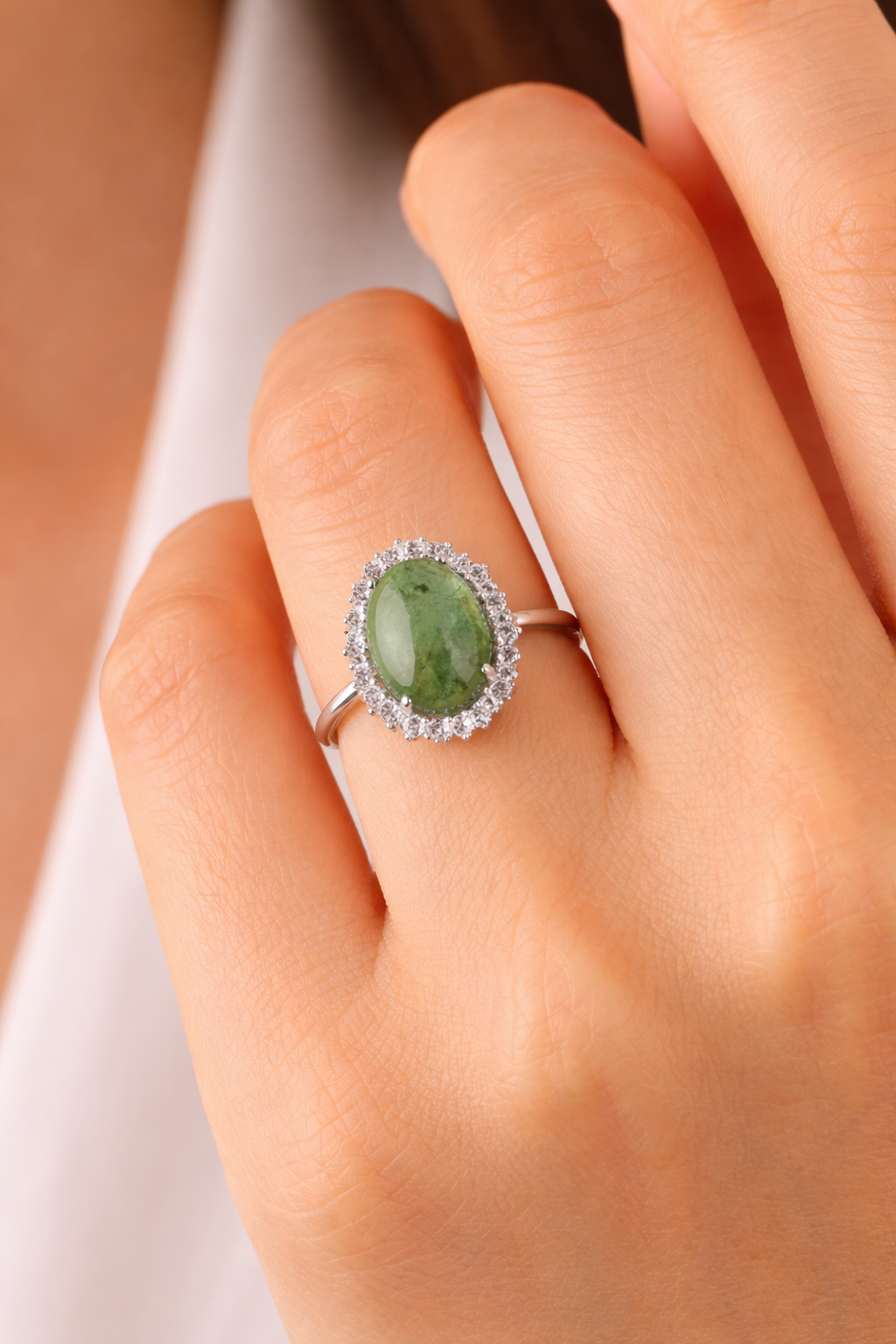 Elegant green gemstone ring with diamonds