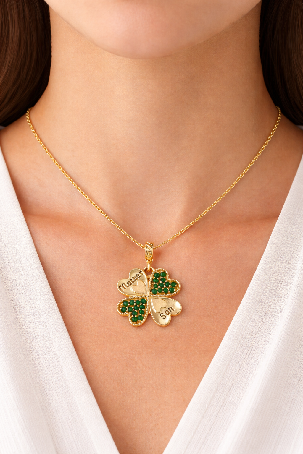 Gold clover necklace with green gemstones
